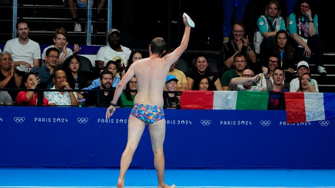 Speedo-wearing man at Olympics swimming event